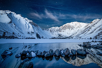 Snowy mountains, starry night, lake, rocks HD wallpaper