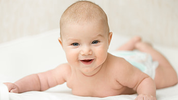 Smiling Cute Baby Is Lying Down On White Bed In Blur Background Cute HD wallpaper