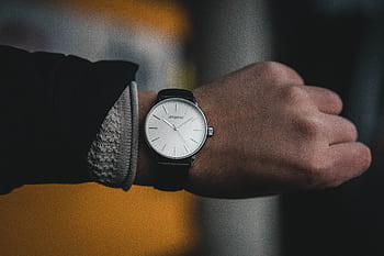 Close-up of a stylish luxury wristwatch on an adult male hand, indoors with a modern timepiece focus. HD wallpaper