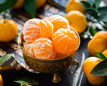 Vibrant peeled and whole tangerines in a rustic bowl highlighting freshness and health. HD wallpaper