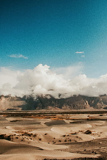 Explore the captivating sand dunes and towering mountains under a vivid blue sky in Leh, India. HD phone wallpaper