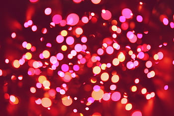 Colorful bokeh featuring bright pink and orange lights creating a festive atmosphere. HD wallpaper