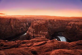 Captivating sunset view of Horseshoe Bend canyon with the Colorado River, showcasing dramatic rock formations and vibrant skies. HD wallpaper