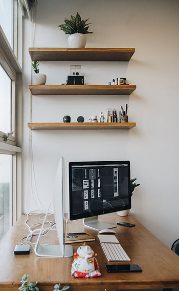 A sleek office workspace featuring a computer, shelves, and minimalist decor. HD phone wallpaper