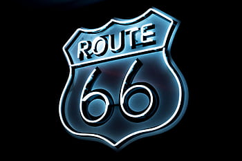 Bright neon Route 66 sign glowing on a black background, vintage style. HD wallpaper