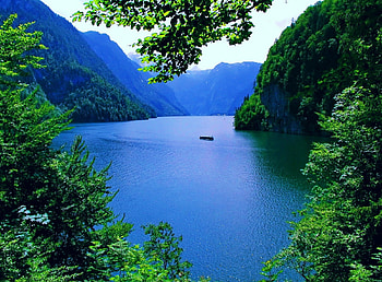 Alpine landscape, blue, river, boat, Alps, lakeshore, ship, nice, shore, reflection, trees, amazing, water, stunning, landscape, beautiful, rocks, lake, mountain, cliffs, branches, view, lovely HD wallpaper