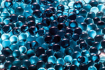 A collection of vibrant blue translucent spheres creating a modern abstract pattern. HD wallpaper