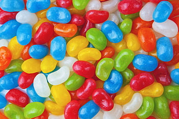 Vibrant and colorful close-up of assorted jelly beans creating a playful and sweet background. HD wallpaper