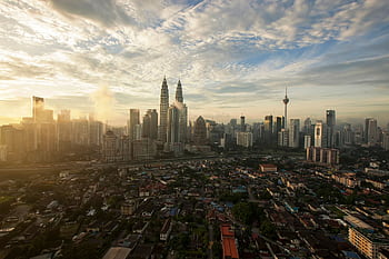 Aerial view of the Kuala Lumpur skyline with iconic landmarks at dawn. HD wallpaper