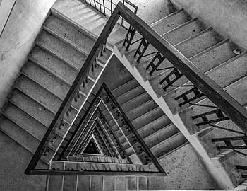 Black and white of a dramatic spiral staircase with geometric patterns and modern design. HD wallpaper