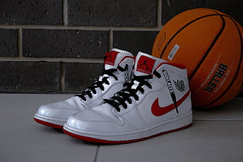 White and red basketball sneakers with an orange basketball on tiled floor. HD wallpaper