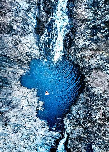 Stunning aerial shot of a crystal-clear blue waterfall pool surrounded by rocky terrain in Australia. HD phone wallpaper
