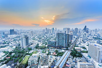 Stunning aerial view of Bangkok cityscape during twilight, showcasing the city's modern skyline. HD wallpaper