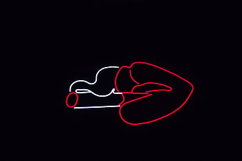 Striking neon sign of lips with a cigarette glowing against a dark background, perfect for modern design themes. HD wallpaper