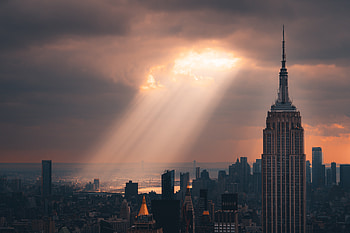 Empire State Radiance: Sunbeam Over NYC Skyline, sunbeam, man made, Empire State Building HD wallpaper