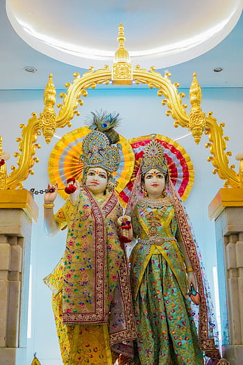 Statues of Krishna and Radha in a Thai temple showcasing vibrant traditional art. HD phone wallpaper