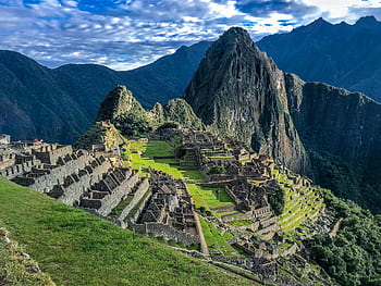 Explore the stunning ancient ruins of Machu Picchu, a UNESCO World Heritage Site in Peru, surrounded by majestic mountains. HD wallpaper