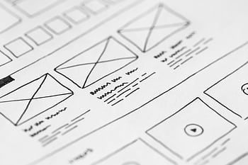 Detailed close-up of a hand-drawn wireframe design on paper for a UX project. HD wallpaper