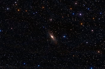 A breathtaking view of the Andromeda Galaxy surrounded by vibrant stars in the night sky. HD wallpaper