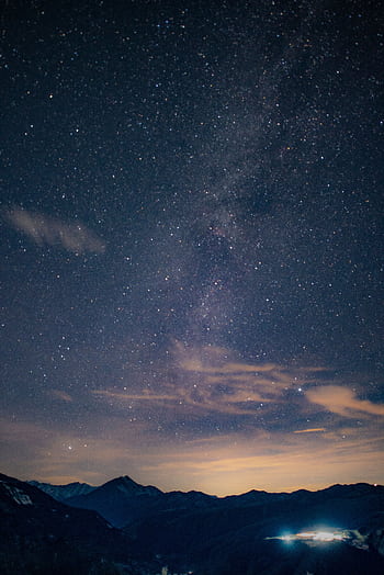 A breathtaking view of the Milky Way galaxy over a mountain range, perfect for night sky enthusiasts. HD phone wallpaper