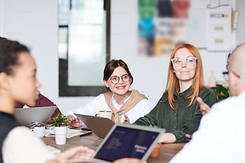 A group of diverse professionals collaborating in a modern office setting. HD wallpaper
