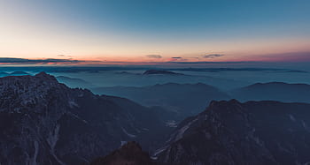 Stunning aerial view of misty mountains at twilight, capturing serene nature. HD wallpaper
