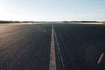 Expansive view of an empty road stretching into the distance under a clear blue sky in Utrecht, Netherlands. HD wallpaper