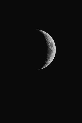 A monochrome of the crescent moon against a black sky, showcasing lunar craters. HD phone wallpaper