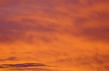 A stunning orange sky captured during a dramatic sunset, showcasing natural beauty. HD wallpaper