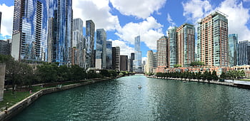 Stunning view of Chicago skyline along the river under a clear blue sky. HD wallpaper