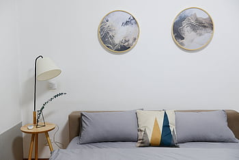 Stylish modern bedroom featuring minimalist decor with abstract wall art and cozy furniture. HD wallpaper