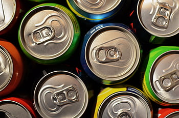Close-up of colorful beverage cans arranged closely together, showcasing various colors. HD wallpaper
