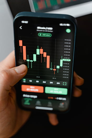 Hand holding smart displaying cryptocurrency trading graph in app. HD phone wallpaper
