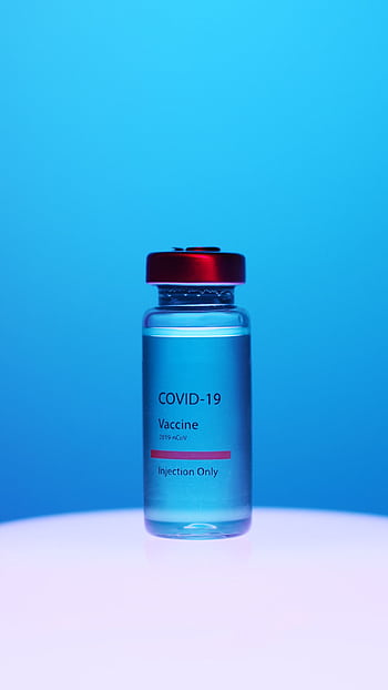 Close-up of a COVID-19 vaccine vial with red cap on a blue background. HD phone wallpaper