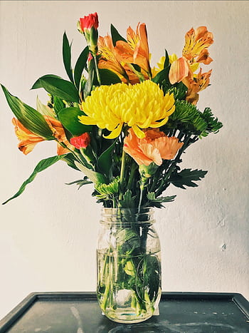 Colorful bouquet of fresh flowers in a mason jar against a simple backdrop. HD phone wallpaper