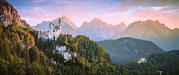 Breathtaking view of Neuschwanstein Castle with Alps in the background during sunset. HD wallpaper