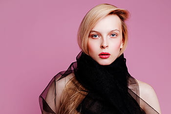 Striking portrait of a woman with blonde hair and red lips against a pink background. HD wallpaper