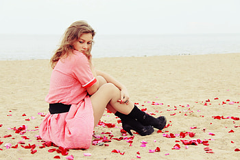 Could it be?, dreamer girl, dreamer, sand, rose petals, colors, beauty, beach, petals, water, sea, beautiful lady, lovely girl, pink dress, love, red, dreaming, face, thinking, hair HD wallpaper