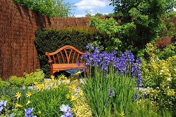 Place for relax, colorful, place, floral, relax, trees, bench, garden, grass, park, stones, summer, stone wall, rest, green, clouds, alley, nature, sky, flowers HD wallpaper