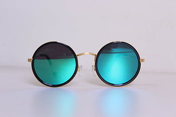 Elegant round sunglasses with blue-tinted lenses and gold frames, perfect for a trendy fashion statement. HD wallpaper