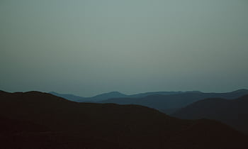 Peaceful dusk scene of Imereti's rolling mountains with a misty horizon. HD wallpaper