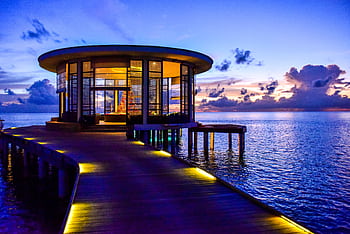 Beautiful round pavilion on a pier overlooking the tranquil sea at sunset. HD wallpaper