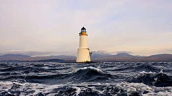 lighthouse in rough seas, sea, lighthouse, waves, clouds, mountains HD wallpaper