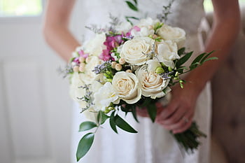 A beautiful bridal bouquet featuring white and pink roses, perfect for a wedding ceremony. HD wallpaper