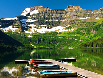 Cameron lake - Waterton park, colorful, lakeshore, crystal, waterton park, peaks, pier, serenity, nice, shore, reflection, boats, greenery, dock, calm, tranquility, showy, beautiful, lake, park, mountain, summer, emerald, cliffs, green, canoes, nature, sky, cameron lake, clear, lovely HD wallpaper