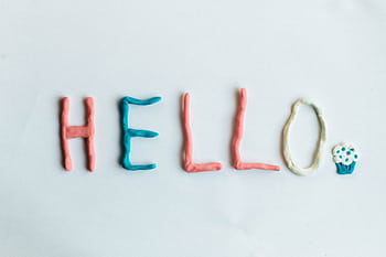 Creative hello greeting spelled out with colorful clay on a white background. HD wallpaper