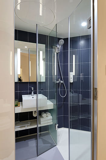 Sleek modern bathroom with a glass shower and contemporary design elements. HD phone wallpaper