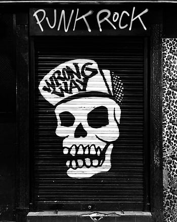 Black and white street art of a skull with cap in Madrid, emits punk vibe. HD phone wallpaper