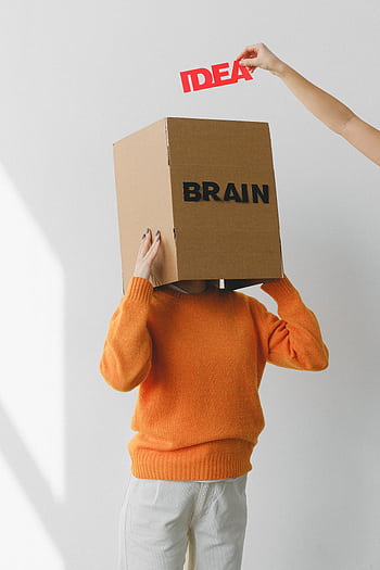 Conceptual of a person with a cardboard box labeled 'BRAIN' and an 'IDEA' cutout. HD phone wallpaper