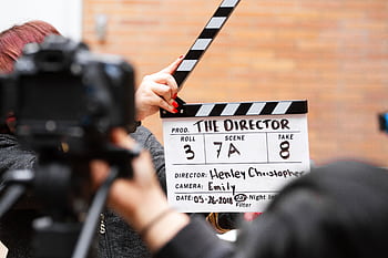 Close-up of film clapperboard in action with camera filming a take on set. HD wallpaper